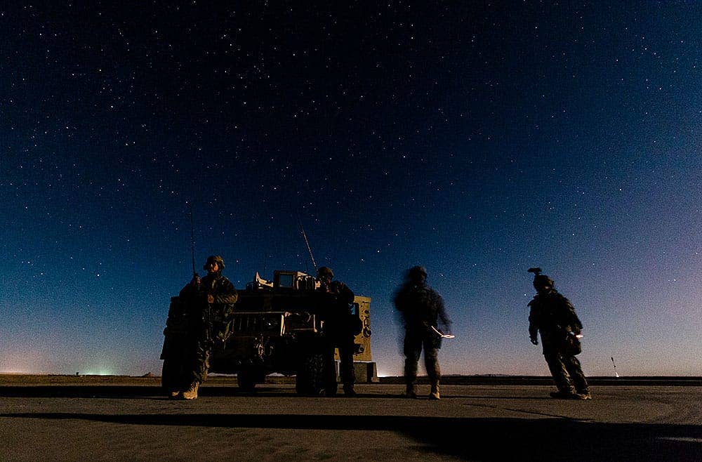 821st Contingency Readiness Group Airmen wait for approaching MH-47 Chinooks at Qayyarah Airfield West, Iraq, Nov. 17, 2016. The 821st CRG is highly-specialized in training and rapidly deploying personnel to quickly open airfields and establish, expand, sustain and coordinate air mobility operations in austere, bare-base conditions. (U.S. Air Force photo by Senior Airman Jordan Castelan)