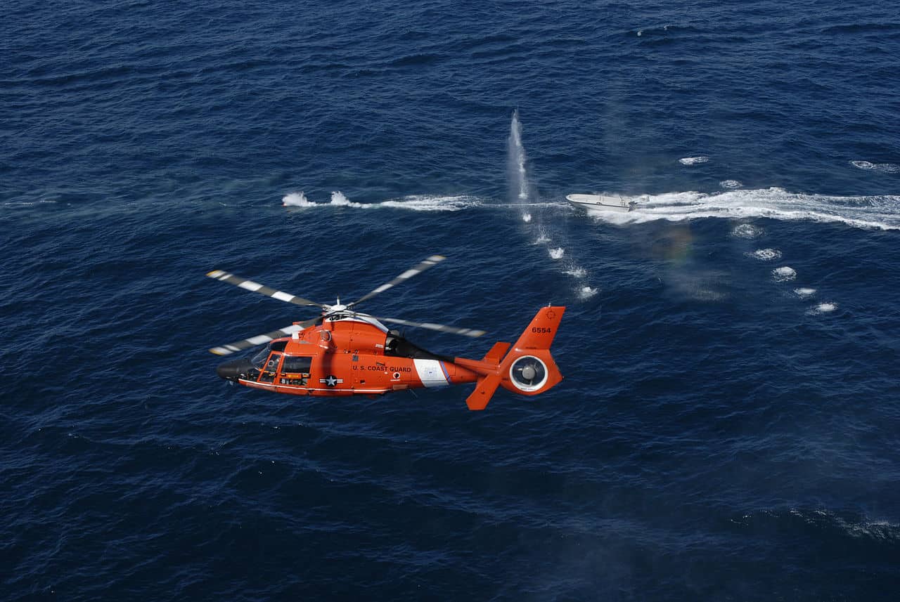 A helicopter crew from the Helicopter Interdiction Tactical Squadron Jacksonville trains off the coast. This is a demonstration of warning shots fired at a non-compliant boat. (U.S. Coast Guard photo/Petty Officer 3rd Class Michael Hulme)