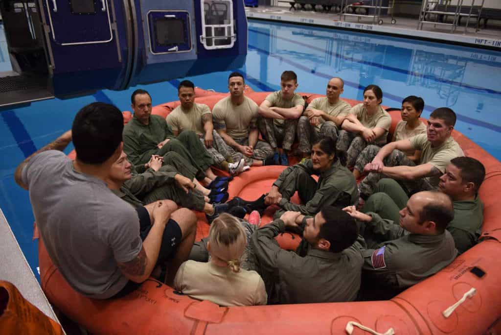 Four NASA astronauts sit in with a class of survival school students being briefed on life raft procedures at Fairchild Air Force Base, Wash., Feb. 10, 2017. (U.S. Air Force photo by Airman 1st Class Ryan Lackey)