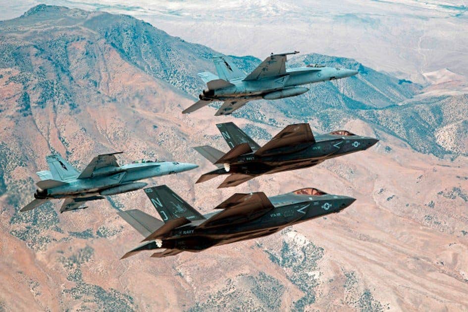 F-35C Lightning IIs, attached to the Grim Reapers of Strike Fighter Squadron (VFA) 101, and an F/A-18E/F Super Hornets attached to the Naval Aviation Warfighter Development Center (NAWDC) fly over Naval Air Station Fallon's (NASF) Range Training Complex. U.S. Navy photo by Lt. Cmdr. Darin Russell/Released