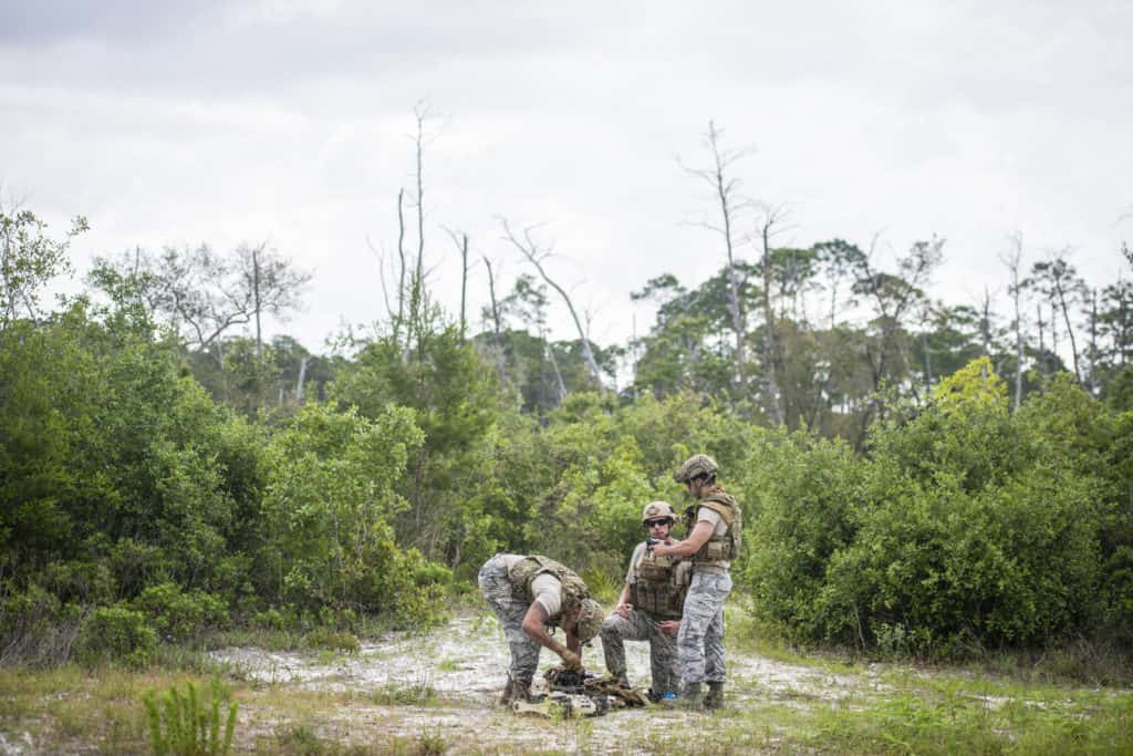 Staff Sgt. James Vossah (Left), Staff Sgt. Brian Wirt (Middle) and Senior Airman Anthony Deleon configure a Micro Tactical Ground Robot (MTGR) to begin a training exercise at Tyndall Air Force Base, Fla. (U.S. Air Force photo/Staff Sgt. Andrew Lee)