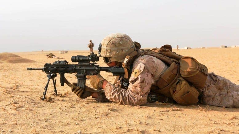 A Marine fires his M27 Infantry Automatic Rifle while conducting squad attack exercise in Bahrain on Dec. 1, 2016. (U.S. Marine Corps photo by Manuel Benavides)