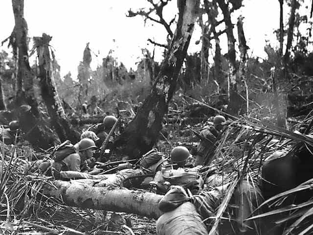 U.S. Marines take cover as Japanese snipers attack. (U.S. Marine Corps photo)
