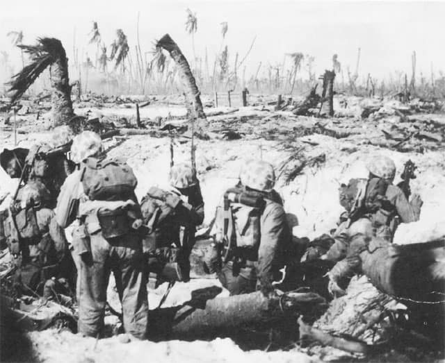 Troops of the 24th Marines near the beach on Namur, thankful for having made it safely ashore, are now awaiting the inevitable word to resume the attack. (USMC photo)