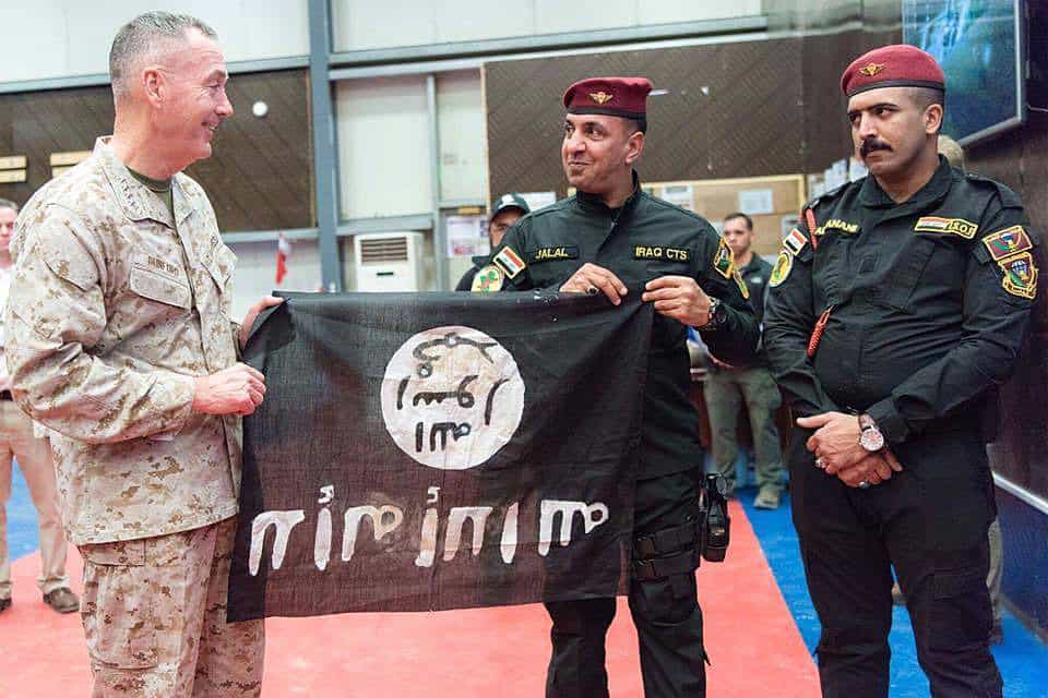 Members of the Iraqi Counter Terrorism Service present Gen. Joseph F. Dunford, chairman of the Joint Chiefs of Staff, a flag from Bartilah, a town recaptured by the Iraqi army just outside of Mosul from the Islamic State of Iraq and the Levant. (DoD photo by Mass Communications Specialist 2nd Class Dominique Pineiro)