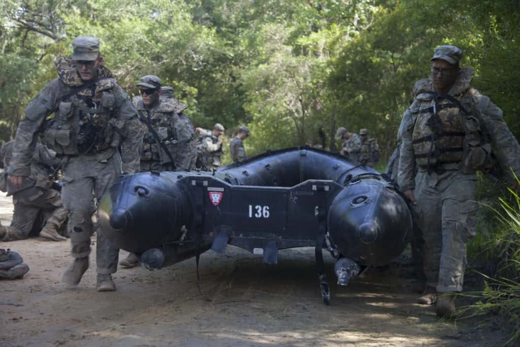 A group U.S. Army Ranger students, assigned to the Airborne and Ranger Training Brigade, carries a zodiac boat to a a river to be able to disembark a mission on Camp Rudder, Eglin Air Force Base, Fl., July 7, 2016. The Florida Phase of Ranger School is the third and final phase that these Ranger students must complete to earn the coveted Ranger Tab. (U.S. Army photo by Sgt. Austin Berner)