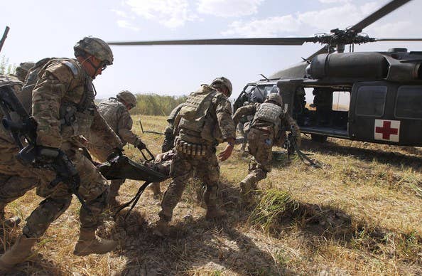 Army medics unload a mock casualty from a UH-60 Black Hawk medevac helicopter during a training exercise at the Joint Readiness Training Center. | U.S. Army photo by Sgt. Michael J. MacLeod