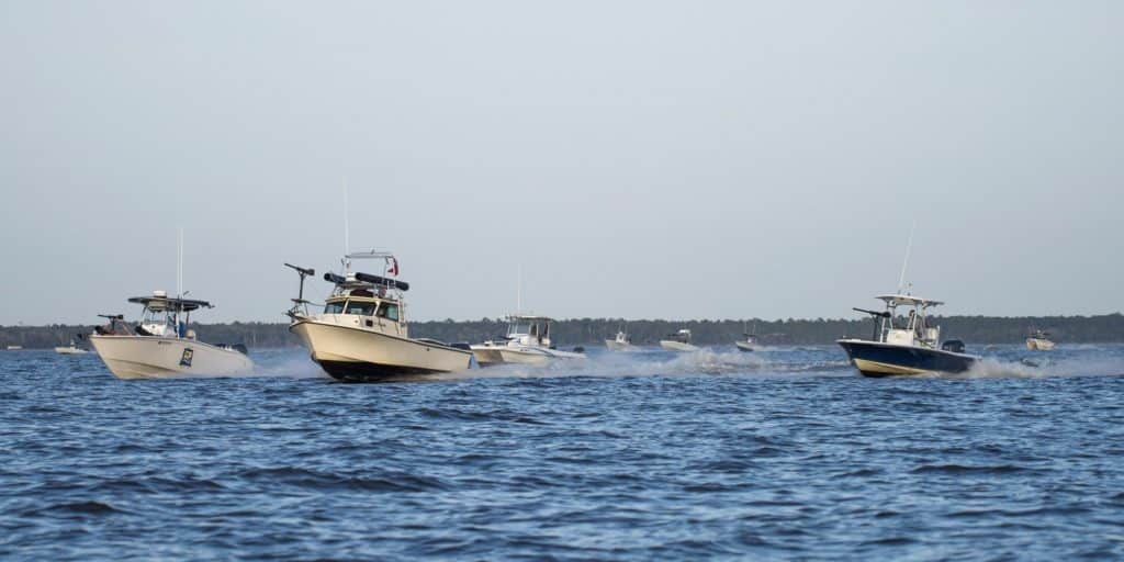 Local boat captains and mariners operate fishing boats equipped with makeshift guns and weapons invaded the Choctawatchee Bay area Feb. 6 during the 86th Fighter Weapons Squadron exercise, Combat Hammer. The boat swarms helped create a realistic environment to provide exercise participants an opportunity to train like they fight. | US Air Force photo by Ilka Cole