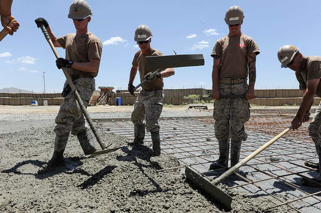 Seabees assigned to Naval Mobile Construction Battalion (NMCB) 15, pour concrete as they work to complete a runway expansion project. NMCB 15 is currently mobilized in support of Operation Enduring Freedom and is an expeditionary element of U.S. Naval Forces that support various units worldwide through national force readiness, civil engineering, humanitarian assistance, and building and maintaining infrastructure. (U.S. Navy photo by Mass Communication Specialist 1st Class Daniel Garas)
