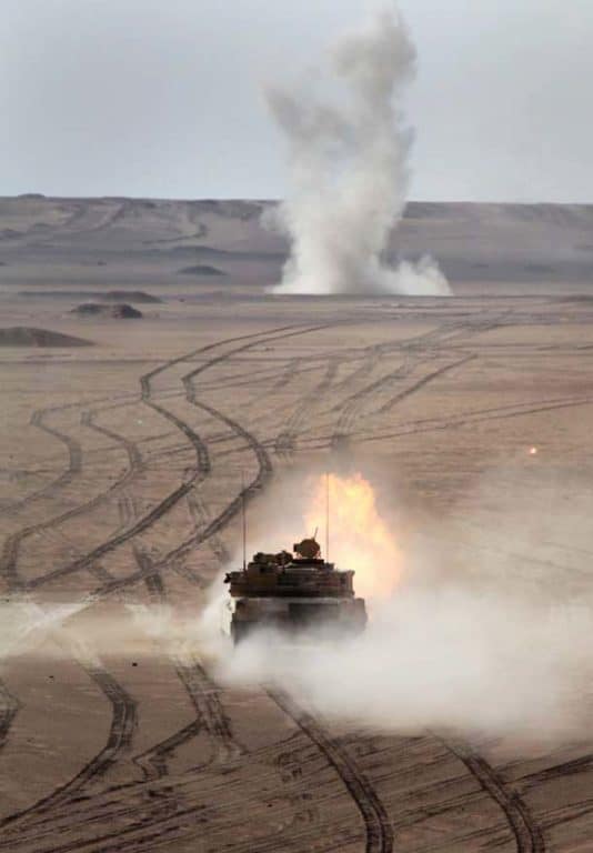An M1A2 Abrams tank fires at a target at a live-fire range near Camp Buehring.(U.S. Marine Corps photo by Cpl. Timothy Childers)