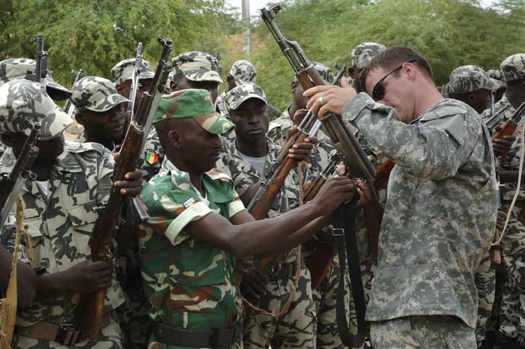 U.S. Army Soldiers from the 3rd Special Forces Group out of Fort Bragg, N.C., help inspect Malian army soldier's weapons at their garrison in Tombouctou, Mali, Sept. 4, 2007, during exercise Flintlock 2007. The exercise, which is meant to foster relationships of peace, security and cooperation among the Trans-Sahara nations, is part of the Trans-Sahara Counterterrorism Partnership. The TSCTP is an integrated, multi-agency effort of the U.S. State Department, U.S. Agency for International Development and the U.S. Defense Department. (U.S. Air Force photo by Master Sgt. Ken Bergmann)
