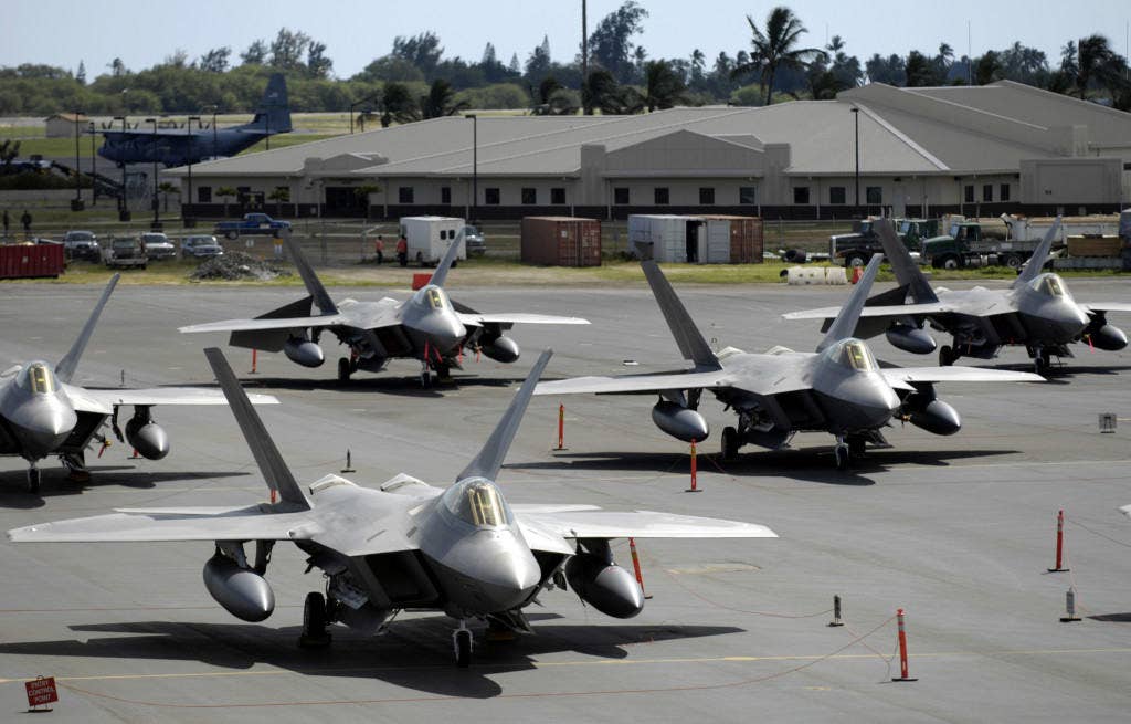 F-22 Raptors sit on the flight line at Hickam Air Force Base, Hawaii Feb. 12. The fighters and more than 250 Airmen from the 27th Fighter Squadron at Langley Air Force Base, Va., are bound for Kadena Air Base, Japan. This is the Raptor's first overseas operational deployment. (U.S. Air Force photo/ Tech. Sgt. Shane A. Cuomo)