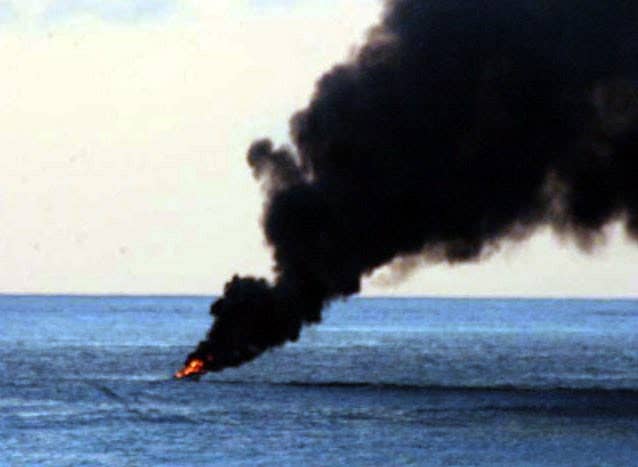 A suspected pirate vessel ignites in flames before burning to the waterline. (U.S. Navy photo)