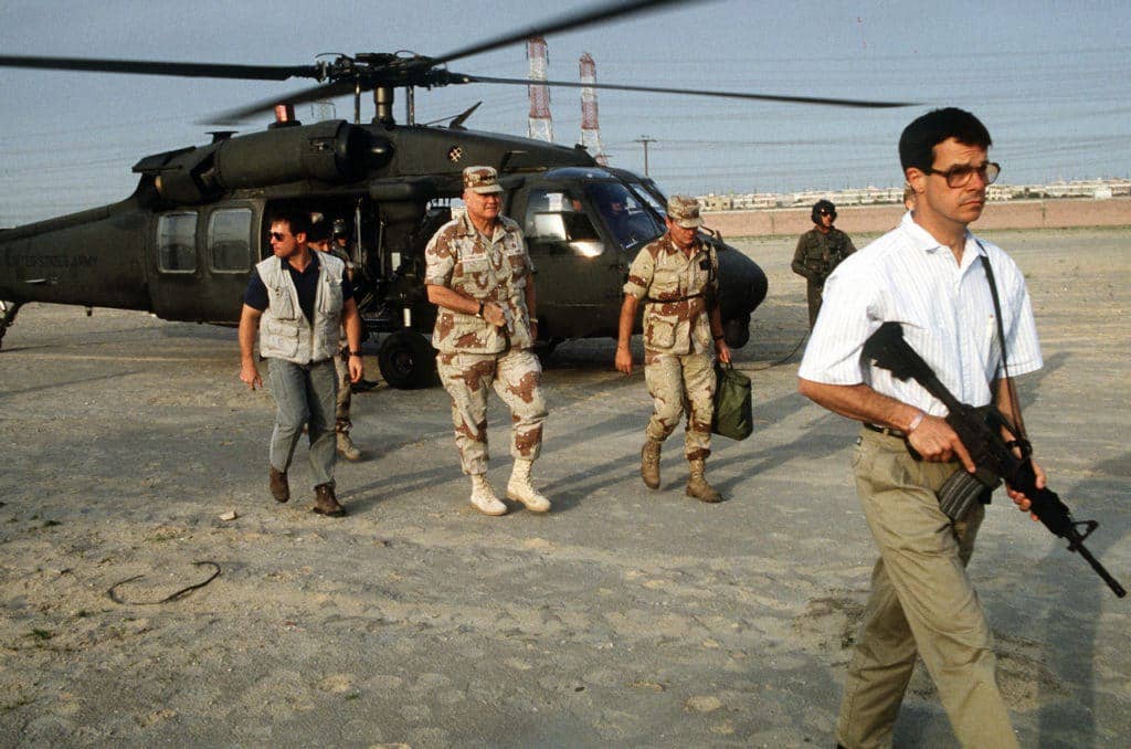 Mike Vining with Delta Force, carring a rifle while others exit a helicopter