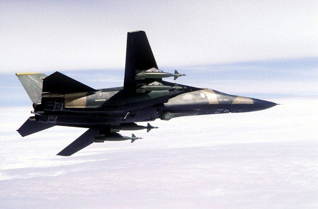 A U.S. Air Force General Dynamics F-111F aircraft, equipped with an AN/AVQ-26 Pave Tack laser target designator, banking to the left over Loch Ness (UK). (USAF photo)