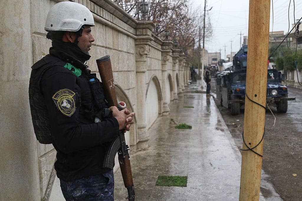 A member of the Iraqi federal police stands guard on a street during operations to liberate and secure West Mosul, Iraq, March 2, 2017. The breadth and diversity of partners supporting the Coalition demonstrate the global and unified nature of the endeavor to defeat ISIS. Combined Joint Task Force-Operation Inherent Resolve is the global Coalition to defeat ISIS in Iraq and Syria. (U.S. Army photo by Staff Sgt. Jason Hull)