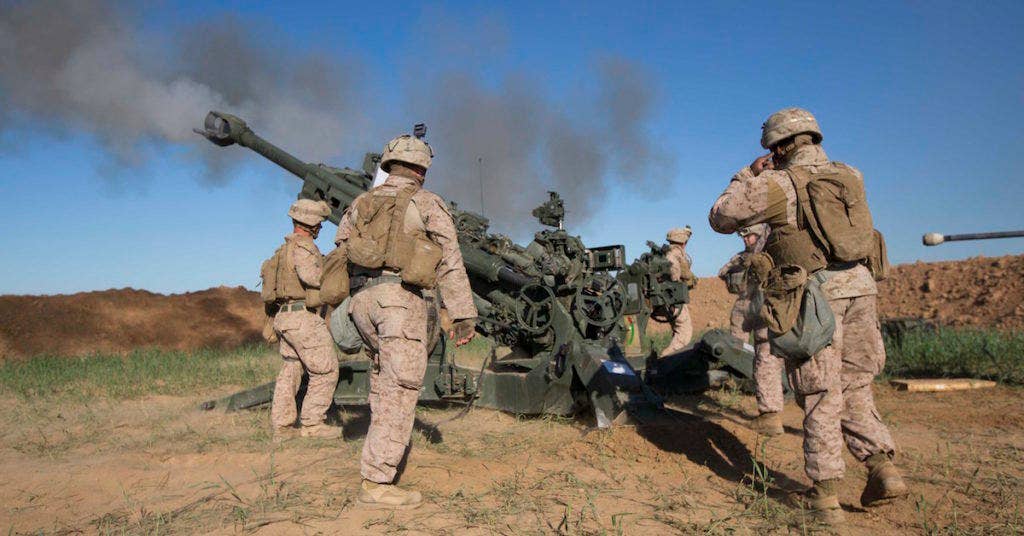 U.S. Marines with Task Force Spartan, 26th Marine Expeditionary Unit (MEU), on Fire Base Bell, Iraq, fire an M777A2 Howitzer at an ISIS infiltration route March 18, 2016. (U.S. Marine Corps photo by Cpl. Andre Dakis)