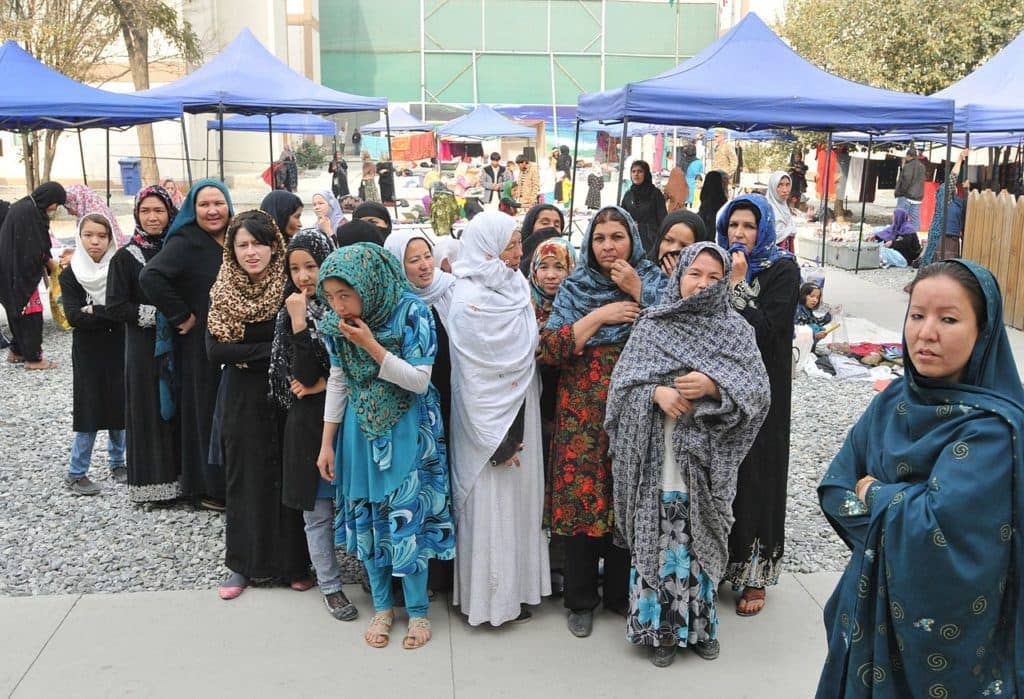 Afghan women and children come to a bazaar to sell home-spun crafts to help support their families through sales of Afghan souvenirs. (U.S. Army photos by Sgt. 1st Class Timothy Lawn, 1st Theater Sustainment Command Public Affairs/Released)