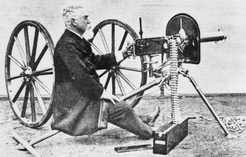 Hiram Maxim sits with the machine gun he invented. (Photo: Public Domain)