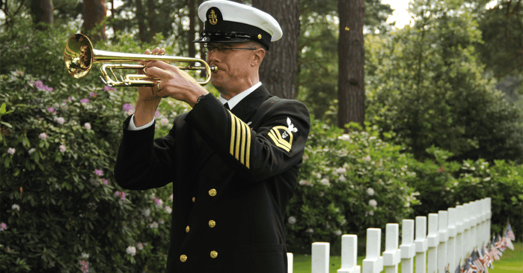 Chief Musician Guy L. Gregg, plays taps during a Memorial Day service at Brookwood American Cemetery.