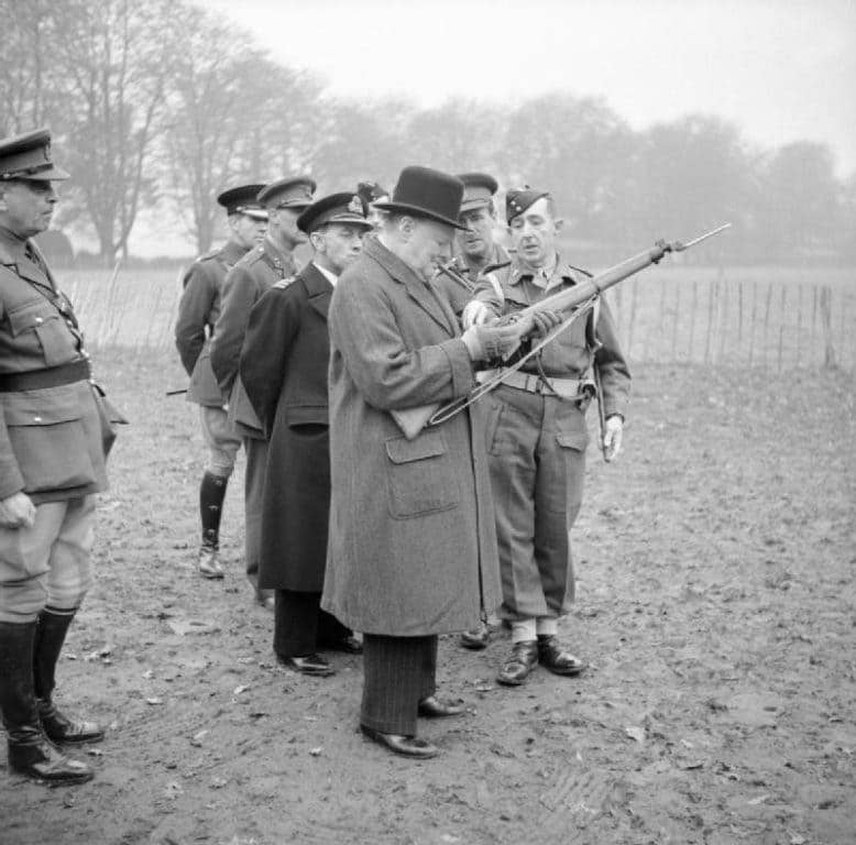  Prime Minister Winston Churchill inspects a sniper rifle 1942. (Photo: British War Office Capt. Horton)