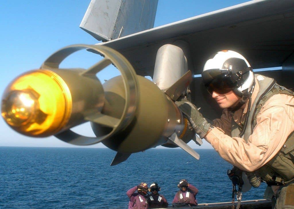 Super Hornet pilot checks a GBU-12 - a laser-guided 500-pounder.