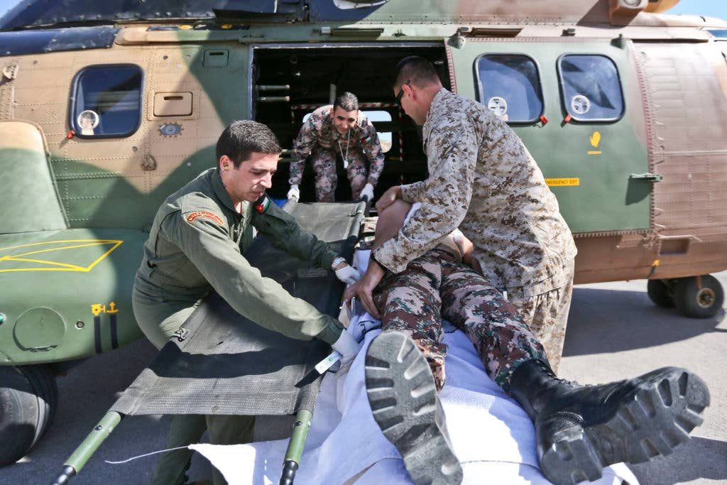 US Navy and Jordanian Armed Forces service members evacuate a simulated casualty into a AS332 Super Puma Helicopter during a medical evacuation drill during Eager Lion 2017 at King Abdullah II Special Operations Training Center Amman, Jordan on May 6, 2017. Eager Lion provides bilateral forces with an opportunity to promote cooperation and interoperability among participating units, build functional capacity, practice crisis management and strengthen our relationship with potential regional threats. (U.S. Marine Corps photo by Cpl. Jessica Y. Lucio)
