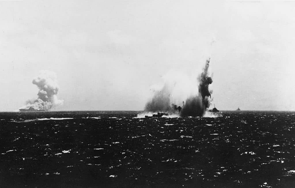 USS O'Brien (DD 415) hit by a torpedo fired by I-19 as USS Wasp (CV 7) burns fro three other torpedo hits from the same spread. (US Navy photo)
