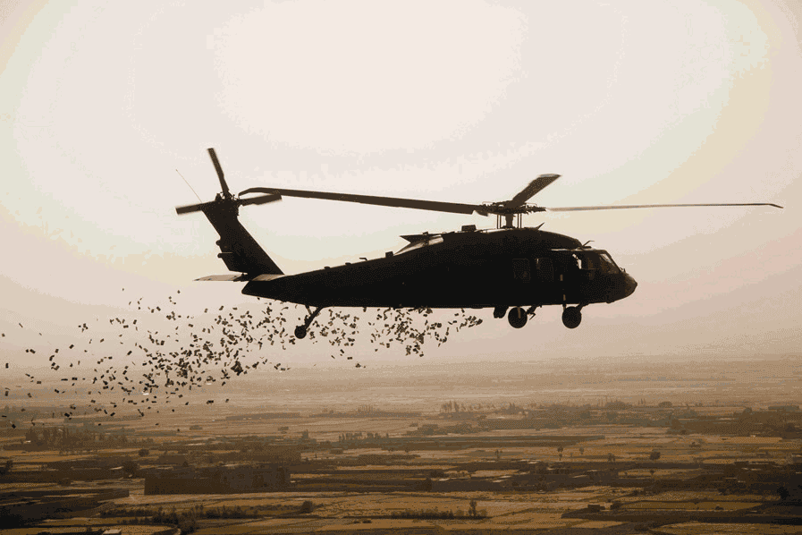 Coalition forces release informational leaflets out of a UH-60 Black Hawk helicopter over villages in the Logar province, Afghanistan, July 18, 2014. The leaflets are used to pass along information to the local populous regarding on going operations in the area. (U.S. Army photo by Spc. Steven Hitchcock)