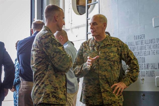 General John Kelly (right), speaks with Lieutenant Col. George Hasseltine, commanding officer of Special Purpose Marine Air Ground Task Force South aboard the USS America. (U.S. Marine Corps photo)