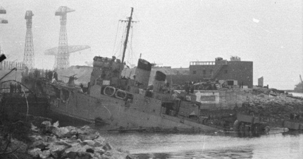 The HMS Campbeltown sits on the lip of the Normandie dock after crashing into it. (Photo: German army archives)