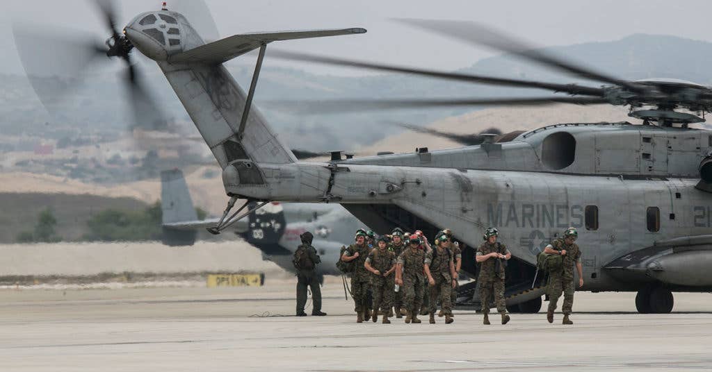 U.S. Marines with Light Attack Helicopter Squadron 369 (HMLA-369), 3d Marine Aircraft Wing, exits a CH-53E Super Stallion upon return from a deployment with the 11th Marine Expeditionary Unit, on Marine Corps Base Camp Pendleton, Calif., May 12, 2017. Friends and family members welcomed home Marines from the 11th MEU's Command Element during a homecoming ceremony. (U.S. Marine Corps photo by Lance Cpl. Clare J. Shaffer/Released)