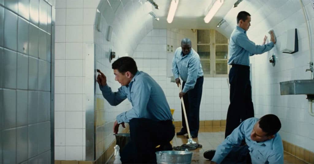 Jake Huard (James Franco), on the left, polishes the bathroom tile with a toothbrush and we don't believe it. (Source: Buena Vista/YouTube/Screenshot)