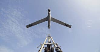 A Scan Eagle unmanned aerial vehicle launches from the amphibious dock landing ship USS Comstock. (Photo by: Department of Defense)
