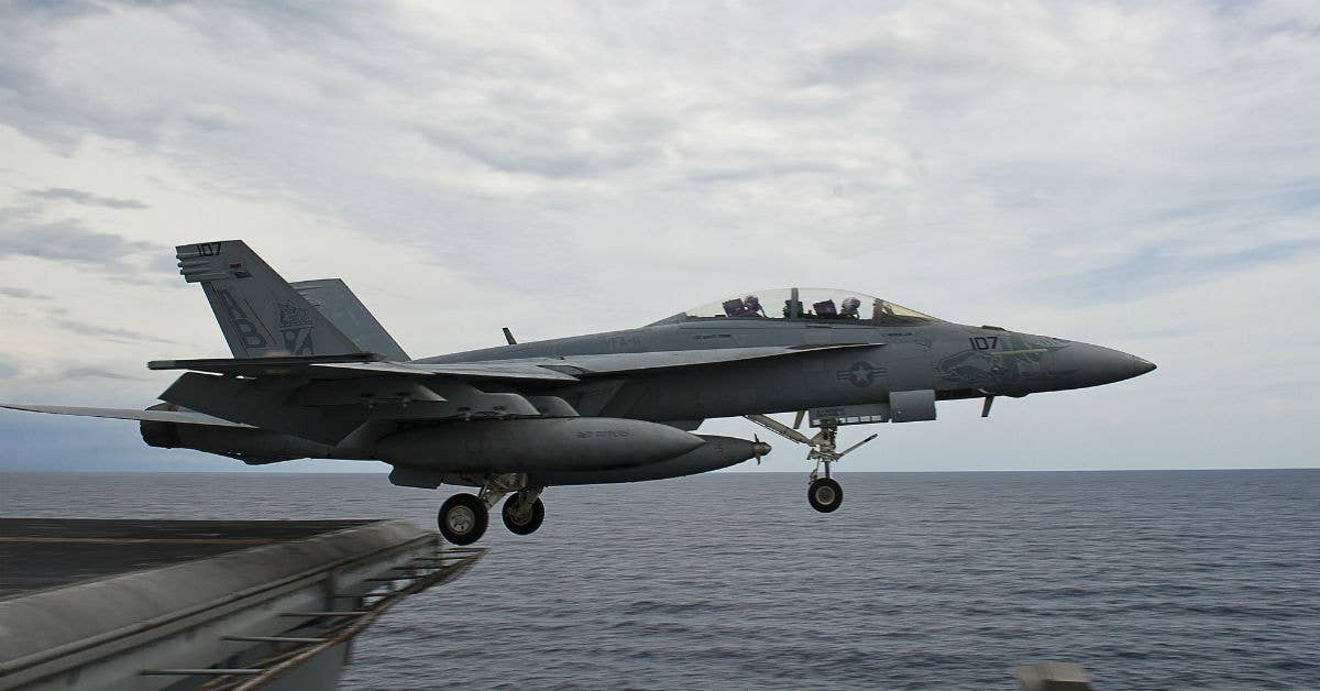 An F/A-18F Super Hornet takes off from the aircraft carrier USS Enterprise (CVN 65) for an aerial change of command ceremony. Photo courtesy of US Navy