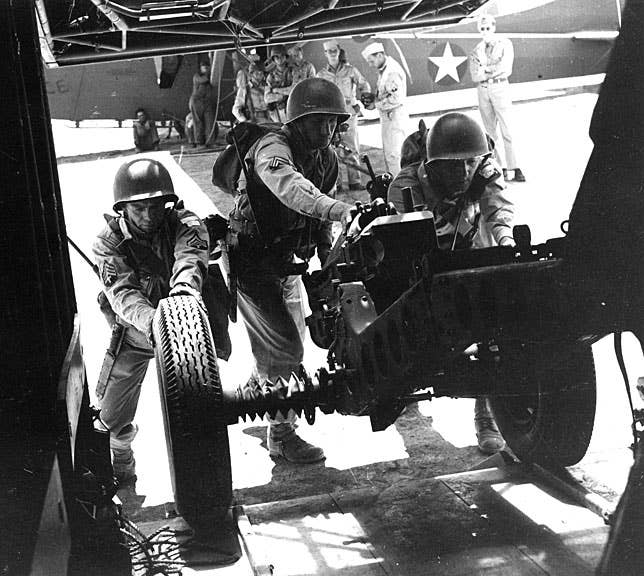 Troops with the 504th Parachute Infantry Regiment load some heavy firepower onto a CG-4 glider. (US Army photo)