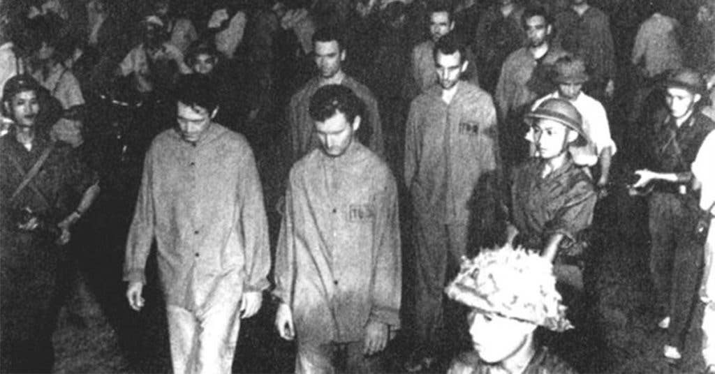Prisoners were paraded before angry crowds in Hanoi, where loudspeakers blared insults and encouraged the crowd's added abuse. Many from the crowd did attack the near defenseless POWs. (Source: National Museum)