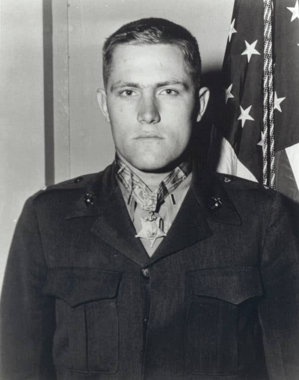 Art Jackson next to a US flag during his time of service