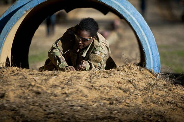 A U.S. Army Infantry soldier-in-training assigned to Alpha Company, 1st Battalion, 19th Infantry Regiment, 198th Infantry Brigade, negotiates the Sand Hill Obstacle Course February 13, 2017, on Sand Hill. (Photo by Patrick A. Albright, Maneuver Center Photographer)