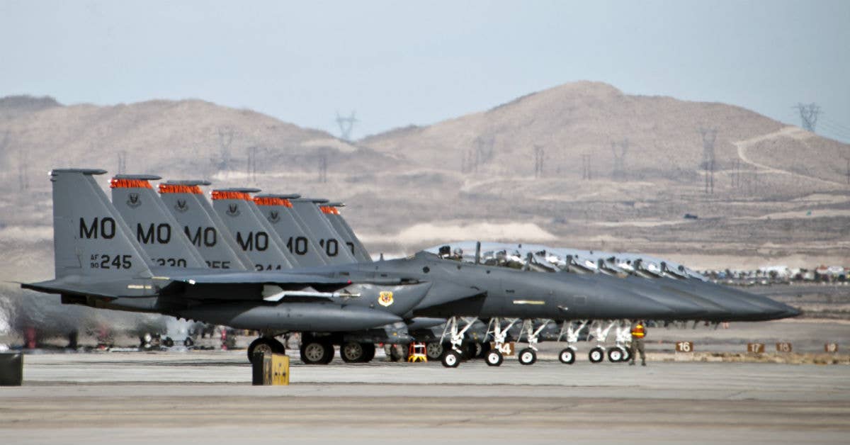 A row of F-15s, laying in wait. USAF photo by Lorenz Crespo.