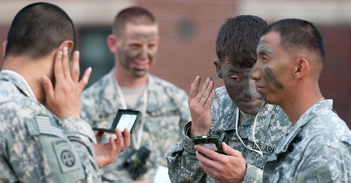 Applying standard camo. Army photo by Sgt. Michael J. MacLeod.