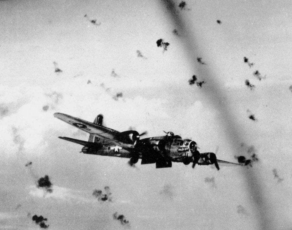 A U.S. Army Air Forces Boeing B-17G Flying Fortress flying through flak over a target. A hit by flak lead to the capture of Brigadier General Arthur Vanaman, placing ULTRA at risk. (USAF photo)
