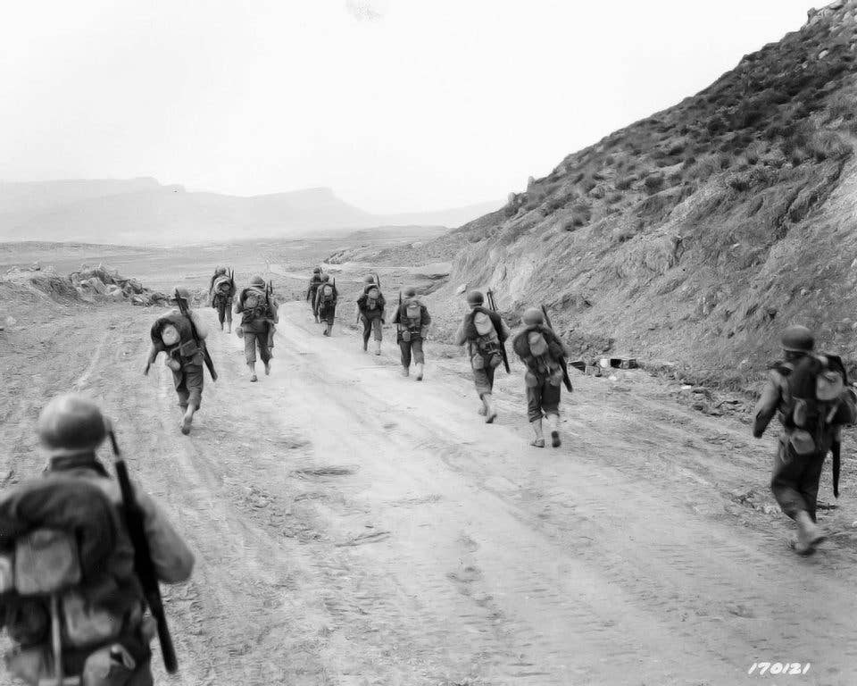 American troops march in the Kasserine Pass in Tunisia. Three of the Roosevelt family's Silver Stars were a result of actions in North Africa. (Dept. of Defense photo)