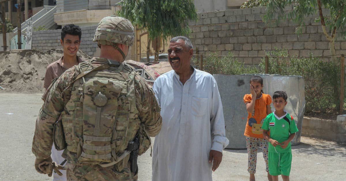 U.S. Army Col. J Patrick Work greets residents in a recently-liberated neighborhood in west Mosul, Iraq, July 2, 2017. (U.S. Army photo by Staff Sgt. Jason Hull)