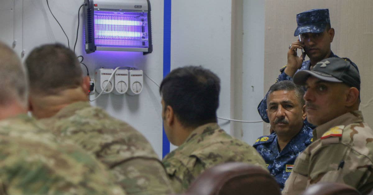 Iraqi security force members and Coalition advisors share information. (U.S. Army photo by Staff Sgt. Jason Hull)