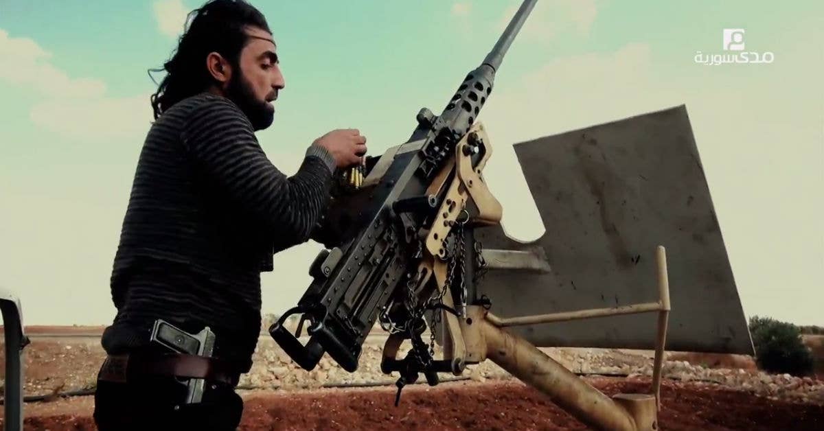 A fighter for the Free Syrian Army loads a US-made M2. The YSA is supplied by the US, but opposes the YPG, also supplied by the US.