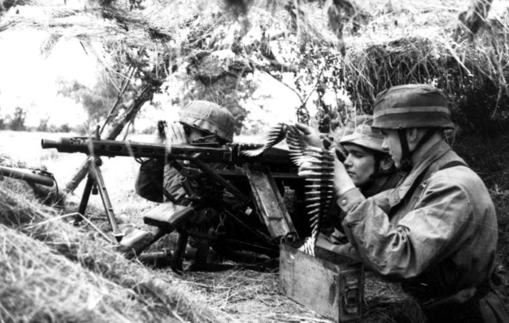German paratroopers open fire with a MG 42 general purpose machine gun. German Bundesarchiv photo.