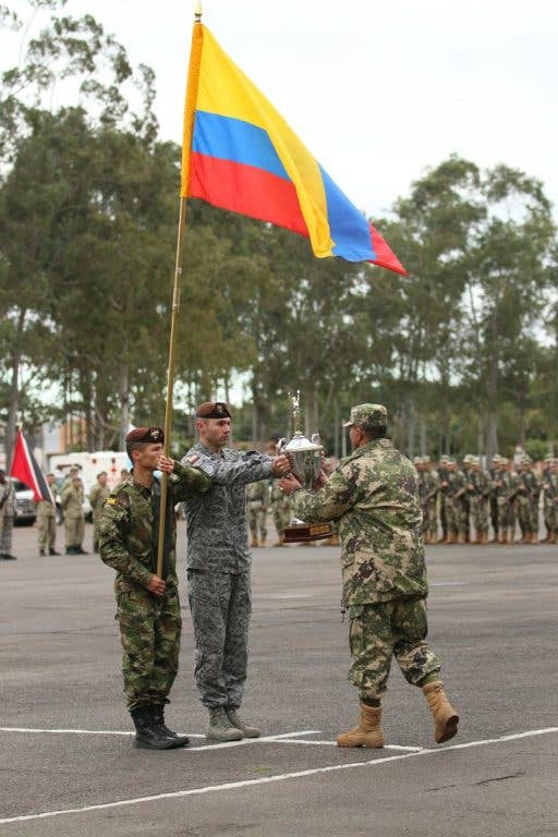 Team Colombia, winners of Fuerzas Comando 2016, return the trophy to Paraguayan Brig. Gen. Hector Limenza at the opening ceremony for Fuerzas Comando 2017 in Mariano Roque Alonso, Paraguay, on July 17, 2017. (U.S. Army photo by Sgt. Christine Lorenz)