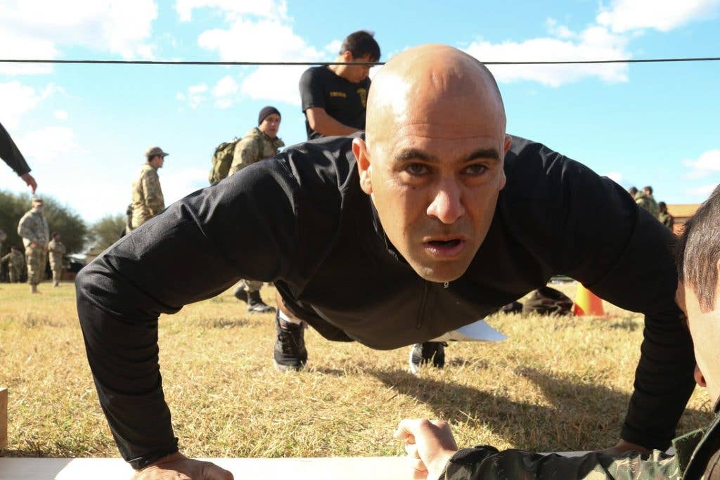 A member from Team Uruguay during the physical fitness test, which includes push-ups, sit-ups, pull-ups, and a 4-mile run. (U.S. Army photo by Spc. Elizabeth Williams)