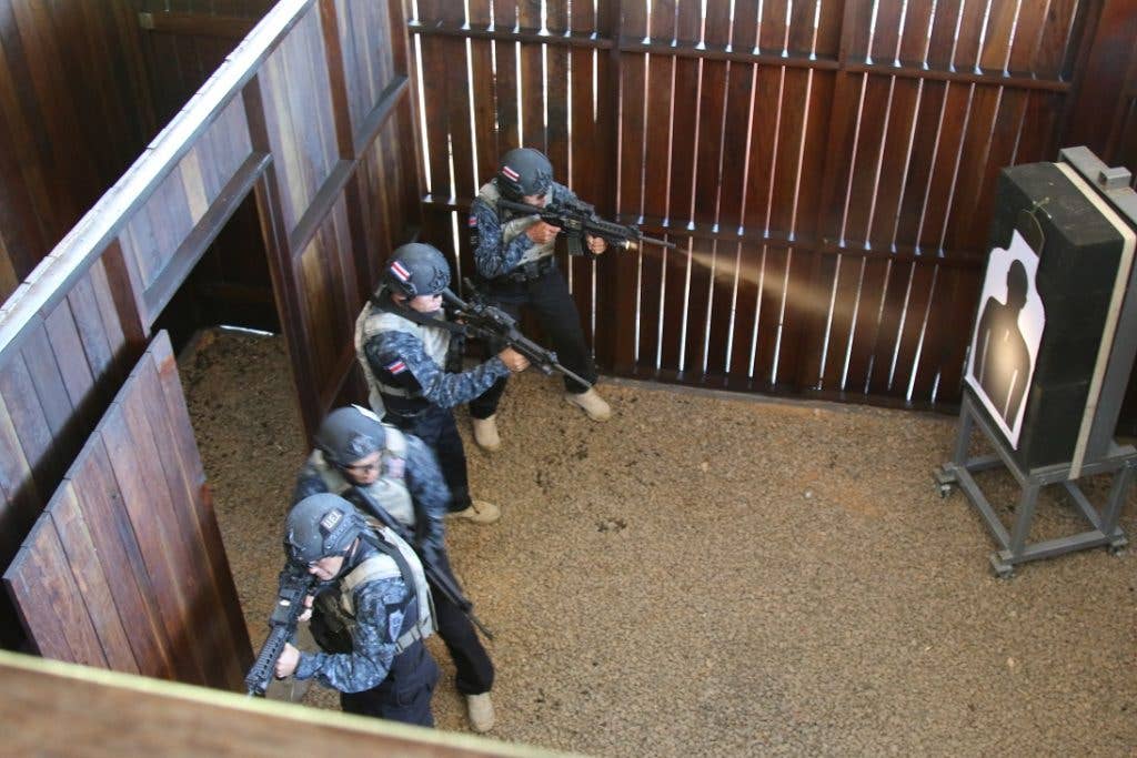Costa Rican competitors clear a room in a live-fire shoot house where they must clear a building and rescue a simulated hostage as efficiently as possible. (U.S. Army photo by Sgt. 1st Class James Brown)